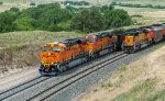 BNSF 5973 and 5698 are eastbound with a loaded coal train passing the westbound DPU unit BNSF 9868 on a returning empty hopper train on Crawford Hill 